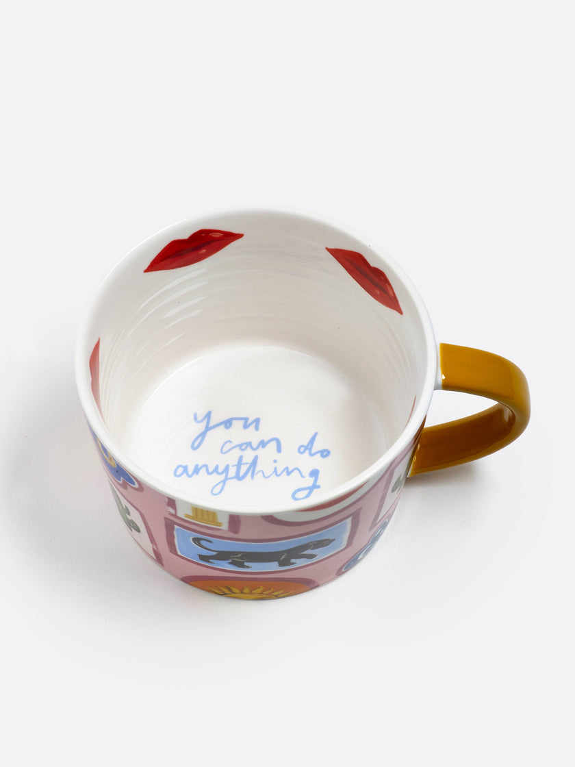 Decorative mug with colorful design and text on a white background