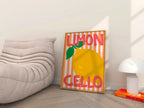 Framed artwork with a lemon illustration and text in a living room setting