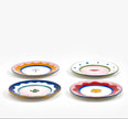 Set of four colorful ceramic plates on a white background