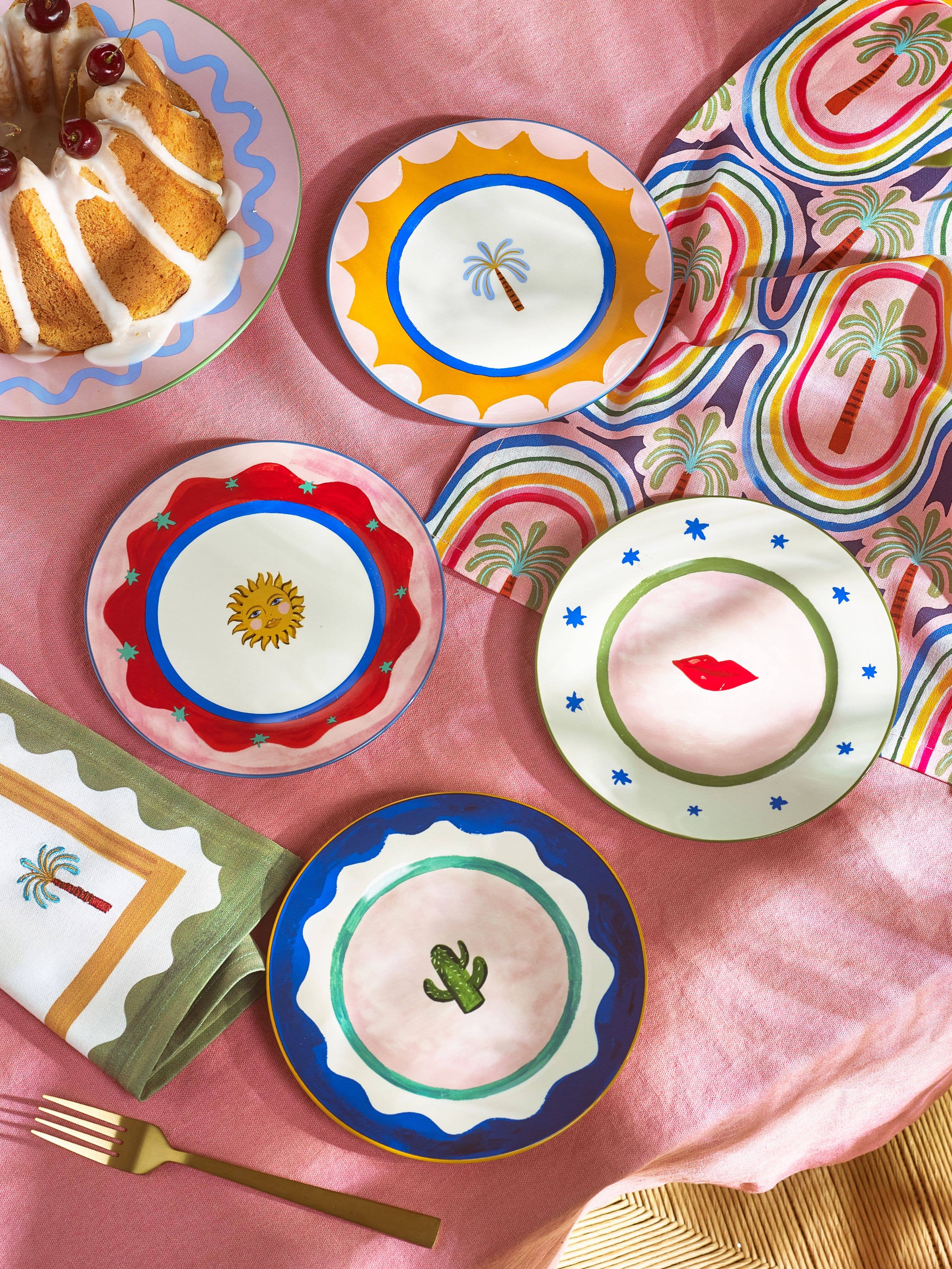 Colorful plates with decorative designs on a pink surface