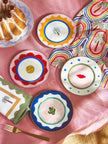Colorful plates with decorative designs on a pink surface