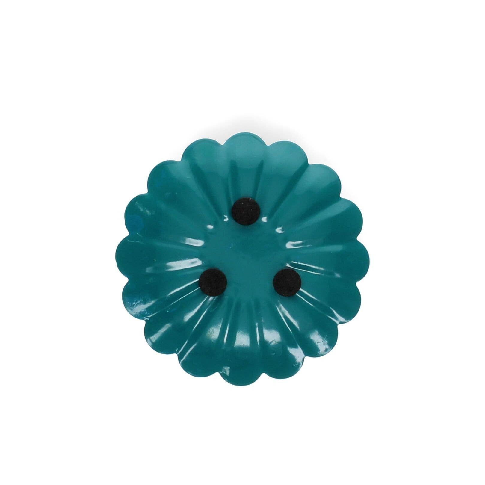 Teal flower-shaped object with black centers on a white background