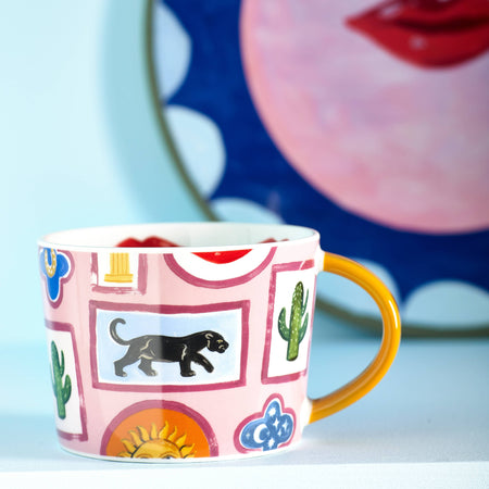 Colorful mug with decorative patterns on a light blue background