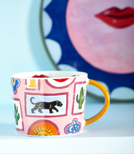 Colorful mug with decorative patterns on a light blue background