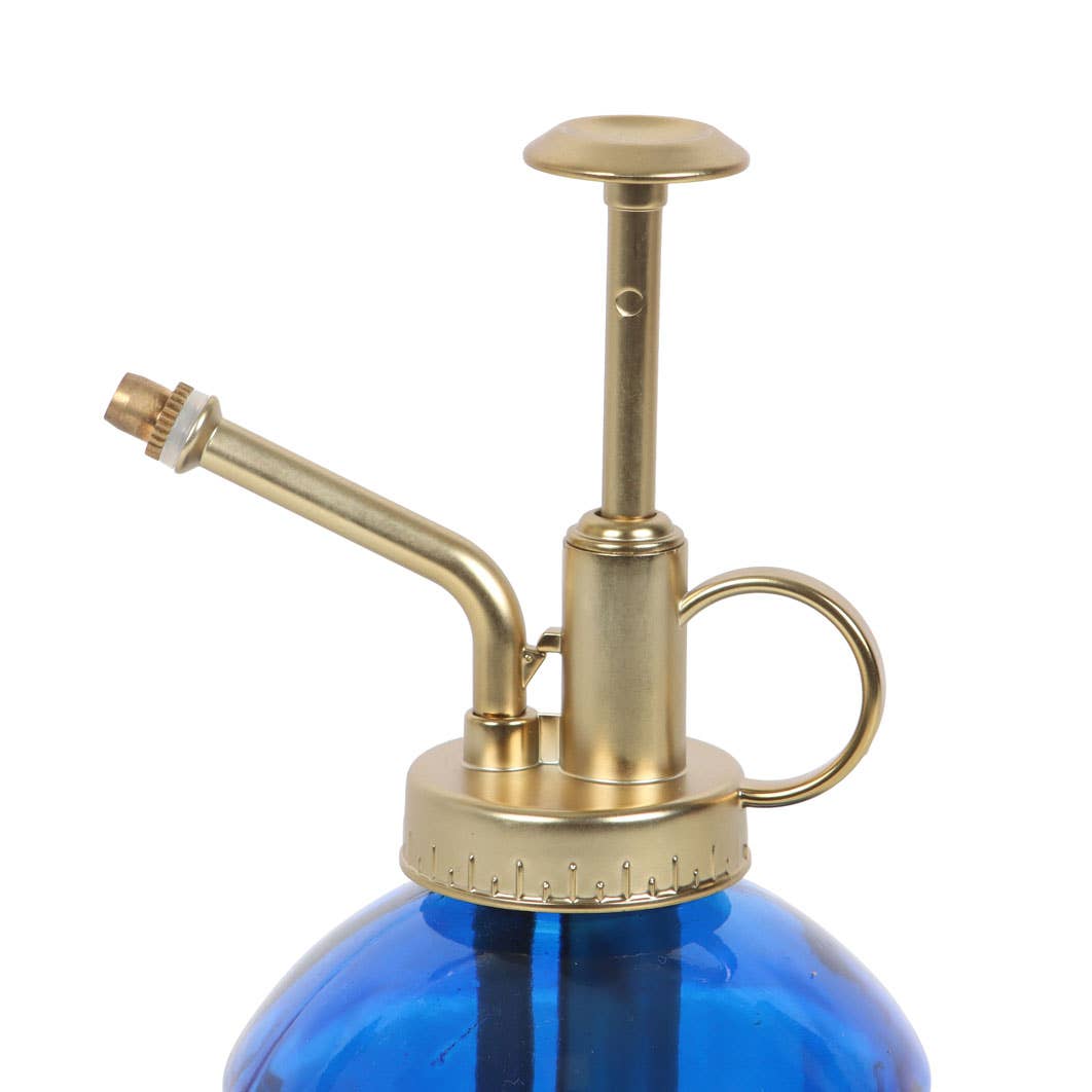 Brass and blue spray bottle on a white background