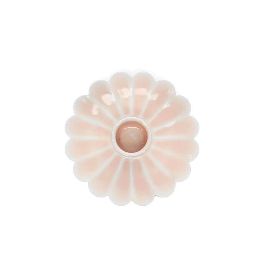 Decorative pink flower-shaped object on a white background