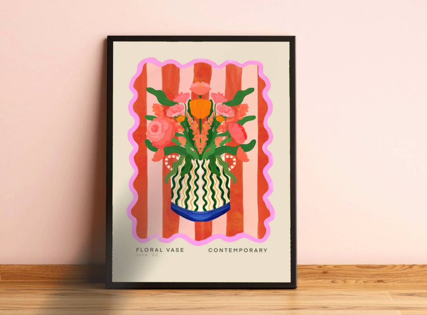 Framed artwork of a floral vase design on a beige wall.