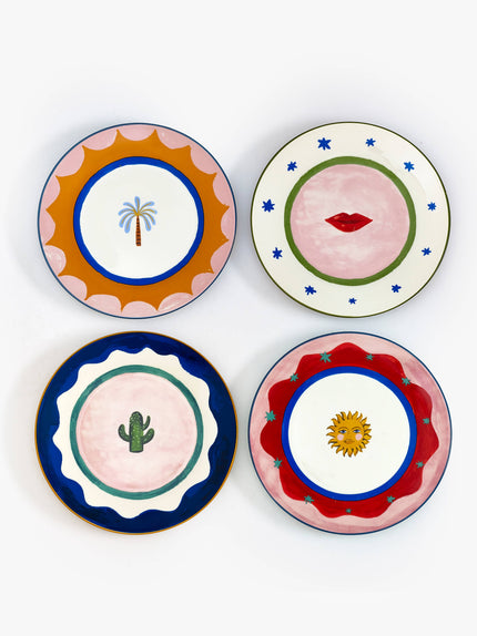 Four decorative plates with unique designs on a white background