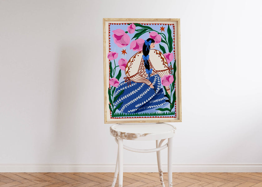 Framed artwork of a woman and flowers on a white wall