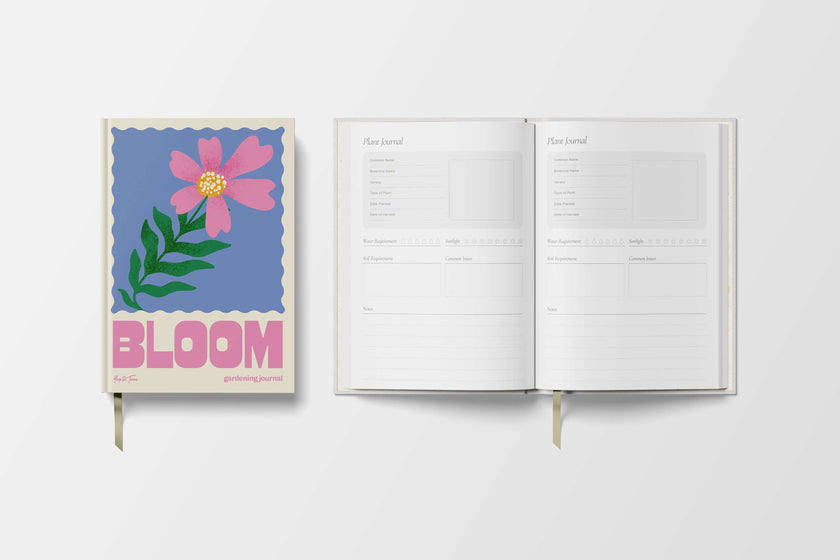 Open planner with floral design and 'BLOOM' text on a white background