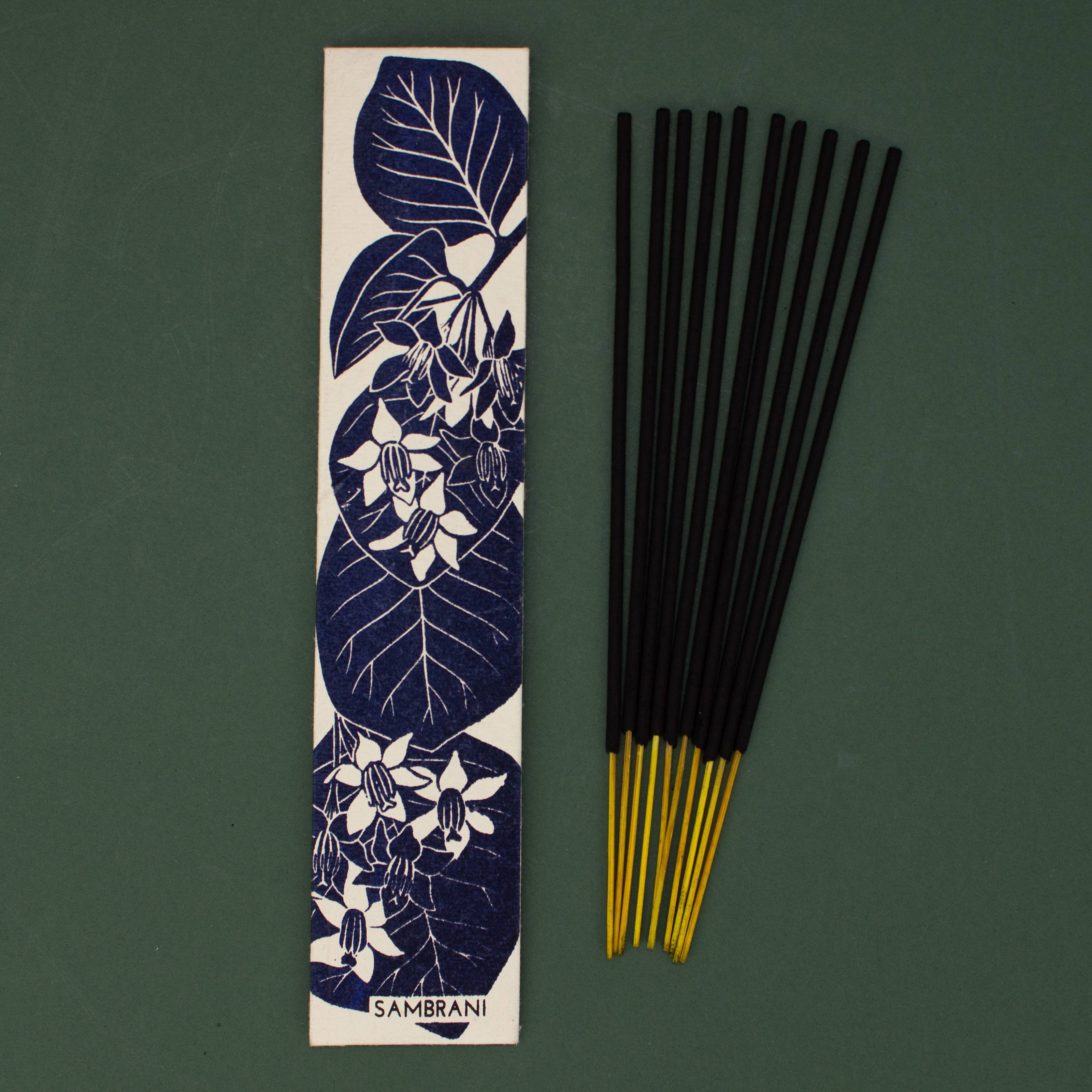 Sambrani incense sticks with a decorative packaging label featuring floral designs on a green background