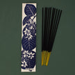 Sambrani incense sticks with a decorative packaging label featuring floral designs on a green background