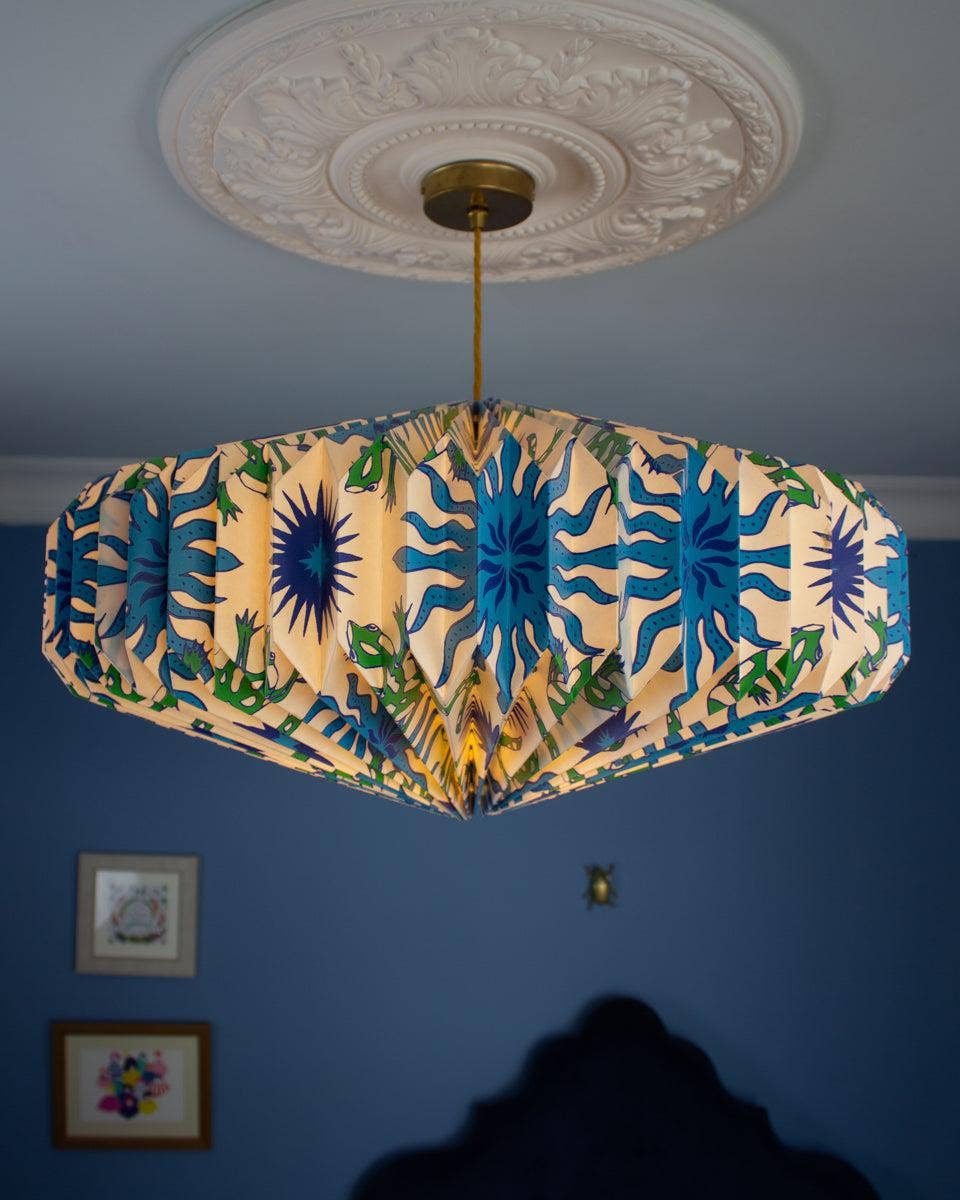 Ceiling lightshade with colourful design against a blue wall