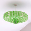 Green and white patterned paper ceiling lampshade on a white background