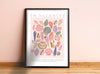 Framed poster with colorful shell design and 'EN VACANCES' text on a pink wall.