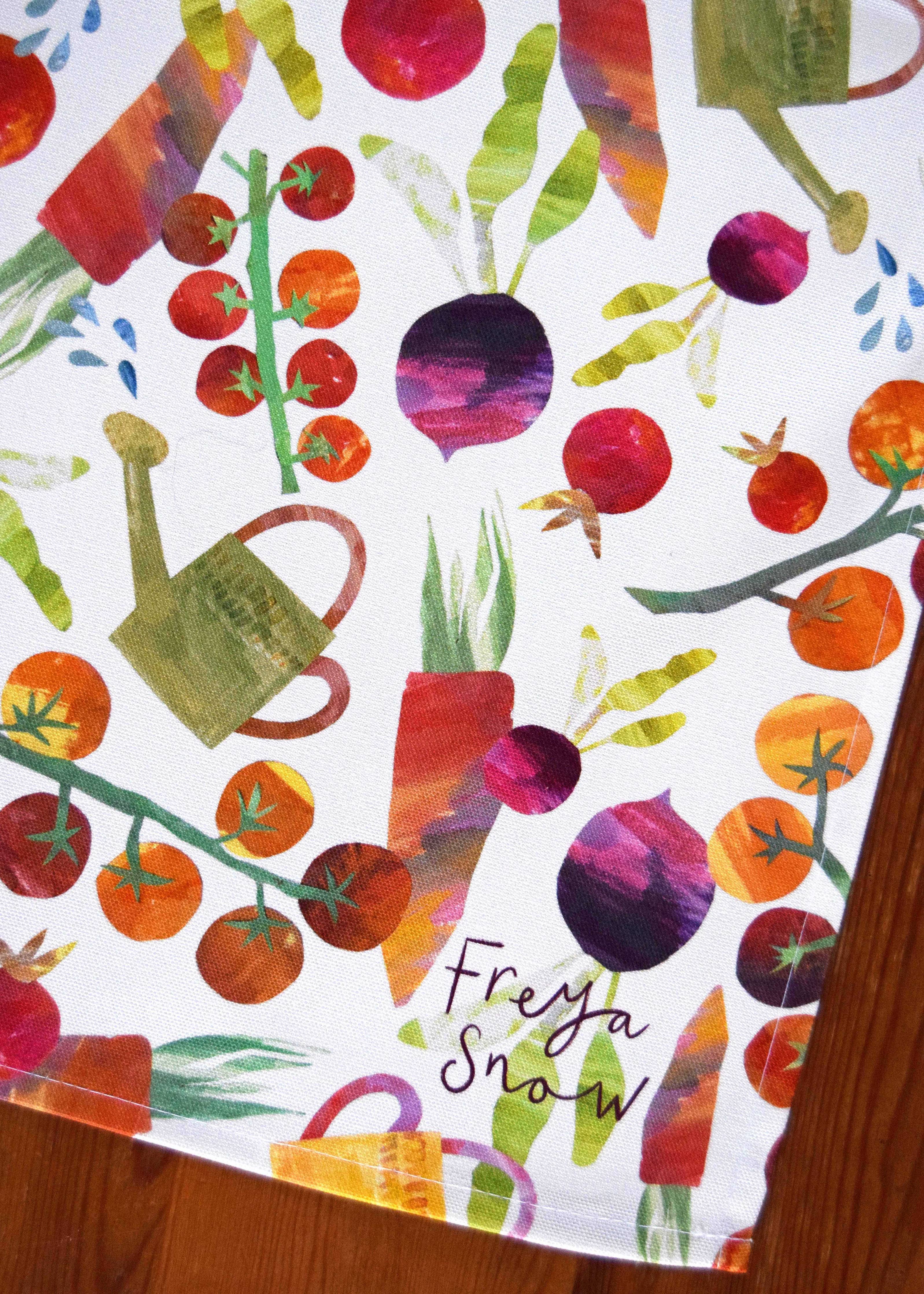 Colorful pattern of vegetables and a watering can on a white background with 'Freya Snow' branding.
