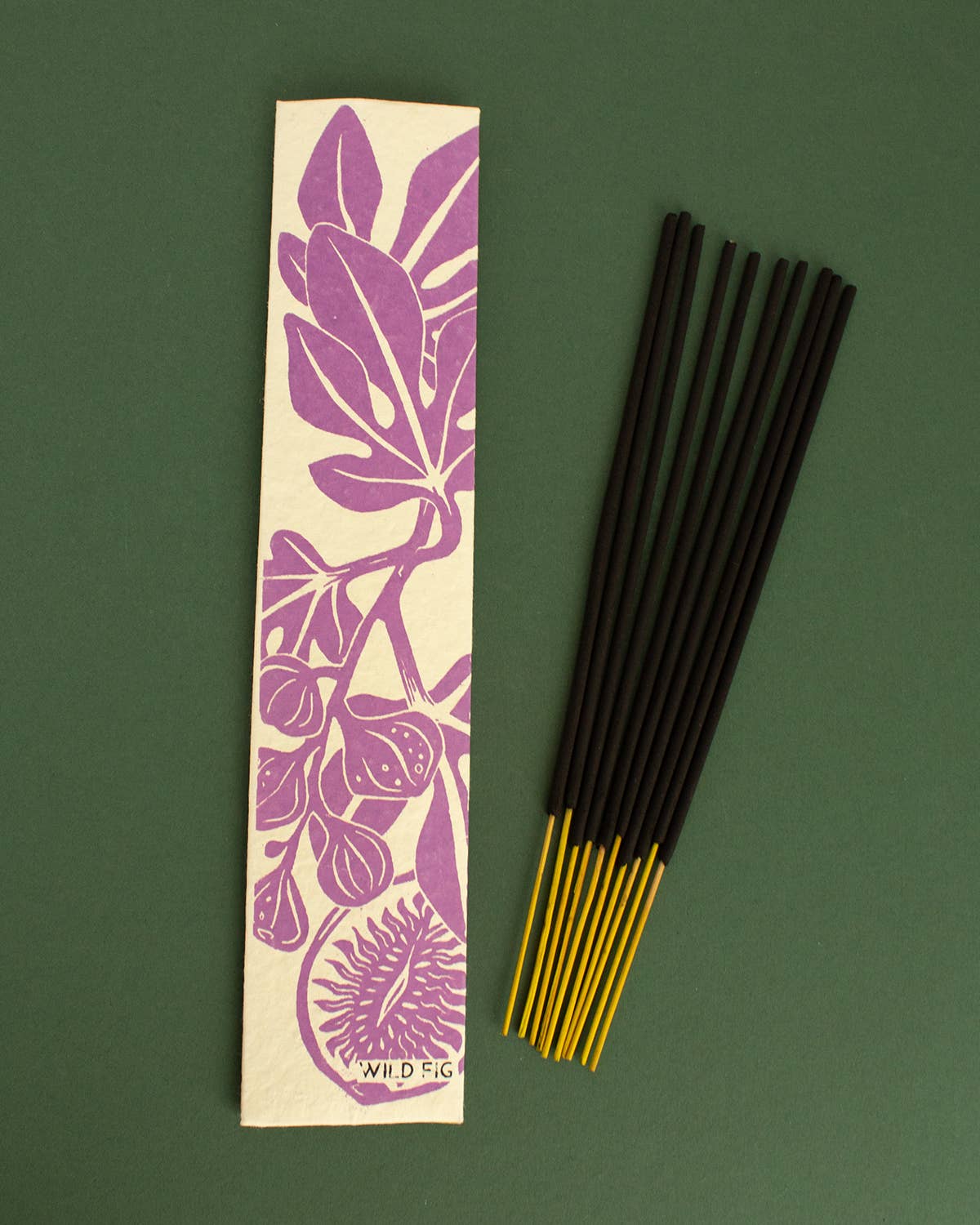 Wild Fig incense sticks with a purple leaf design on a green background