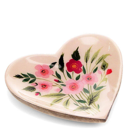 Heart-shaped dish with floral design on a white background