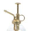Brass and glass plant mister on a white background