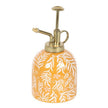 Decorative yellow plant mister with floral pattern on a white background