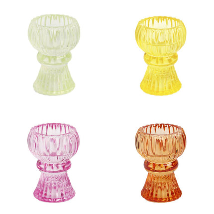 Four colorful glass candle holders on a white background