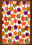 Towel with colorful bell pepper pattern on a wooden surface