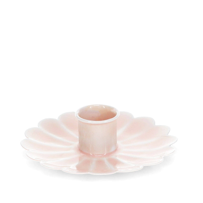 Pink cast metal low candle holder on a white background