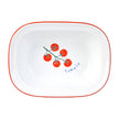 White dish with red rim and tomato design on a white background
