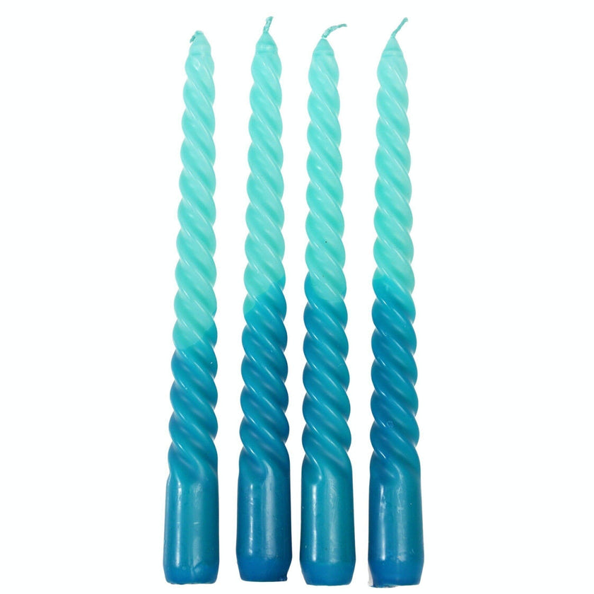 Four blue dip dye twisted candles on a white background