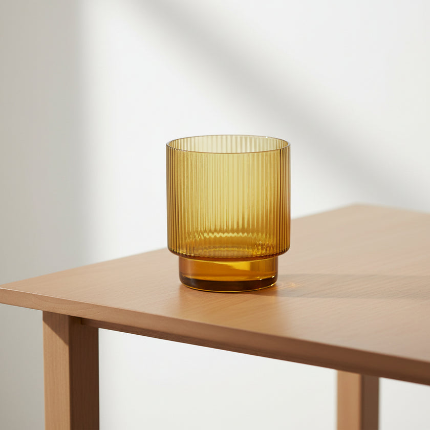 Amber glass with ribbed texture on a white background