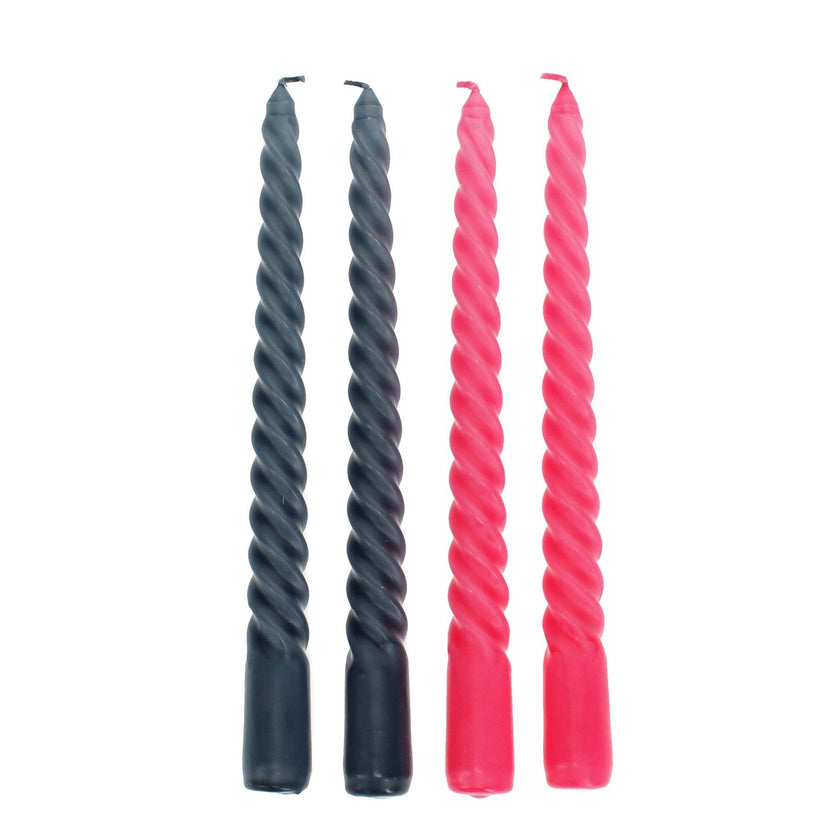 Two pairs of twisted candles, one dark grey and one bright pink, on a white background.