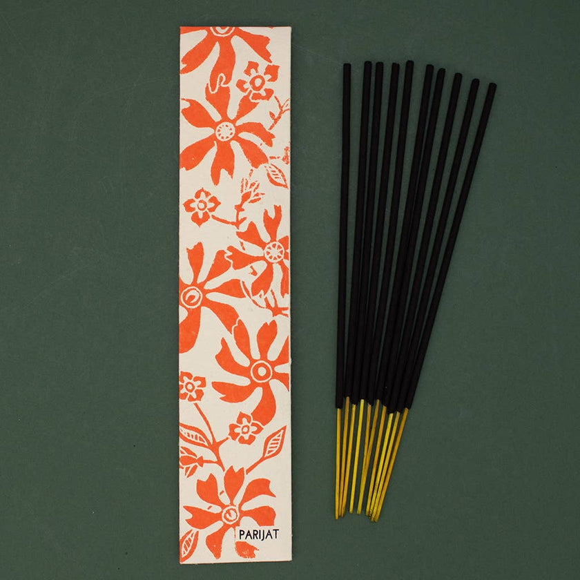 Parijat incense sticks with a floral packaging label on a green background