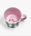 Mug with pink interior and floral exterior on a white background