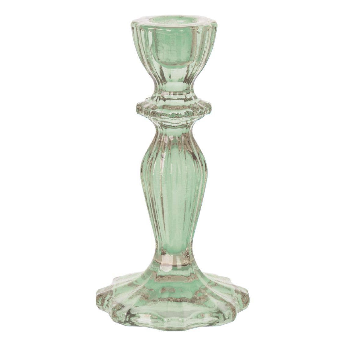 Green glass candle holder on a white background