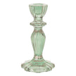 Green glass candle holder on a white background