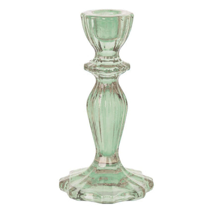 Green glass candle holder on a white background