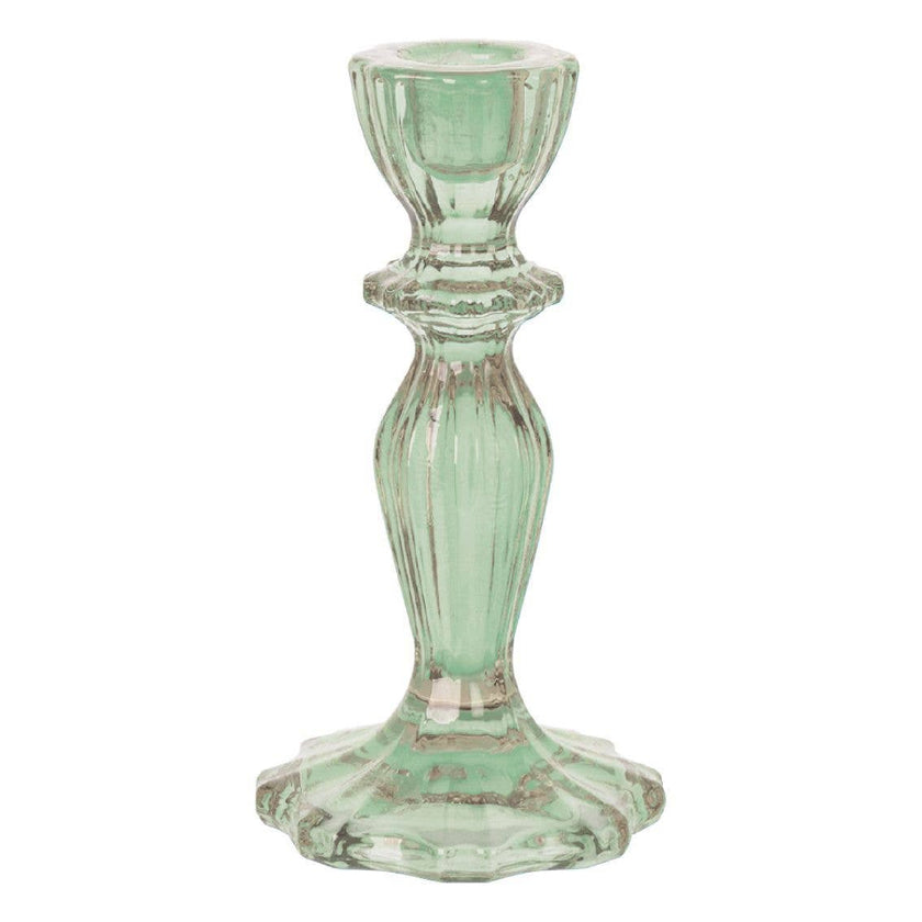 Green glass candle holder on a white background