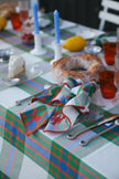 Colourful plaid tablecloth with a matching napkins embroidered with a crab and lobster.