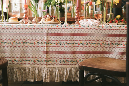 Decorative tablecloth with floral pattern on a table set for a meal.