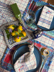 Dining table set with blue check placemats