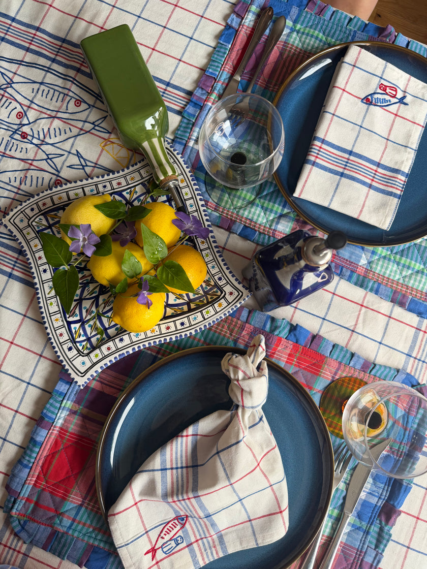 Dining table set with blue check placemats