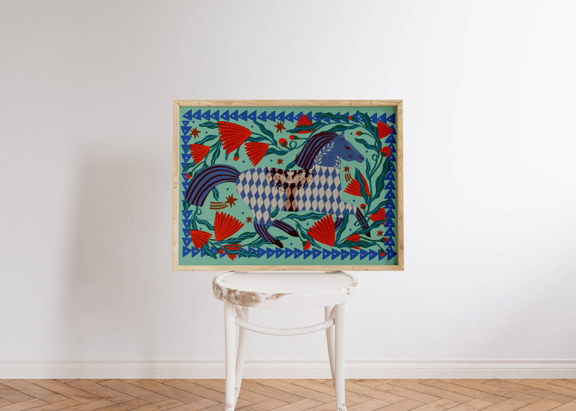 Colourful folksy painting with a horse on a white wall above a white chair.