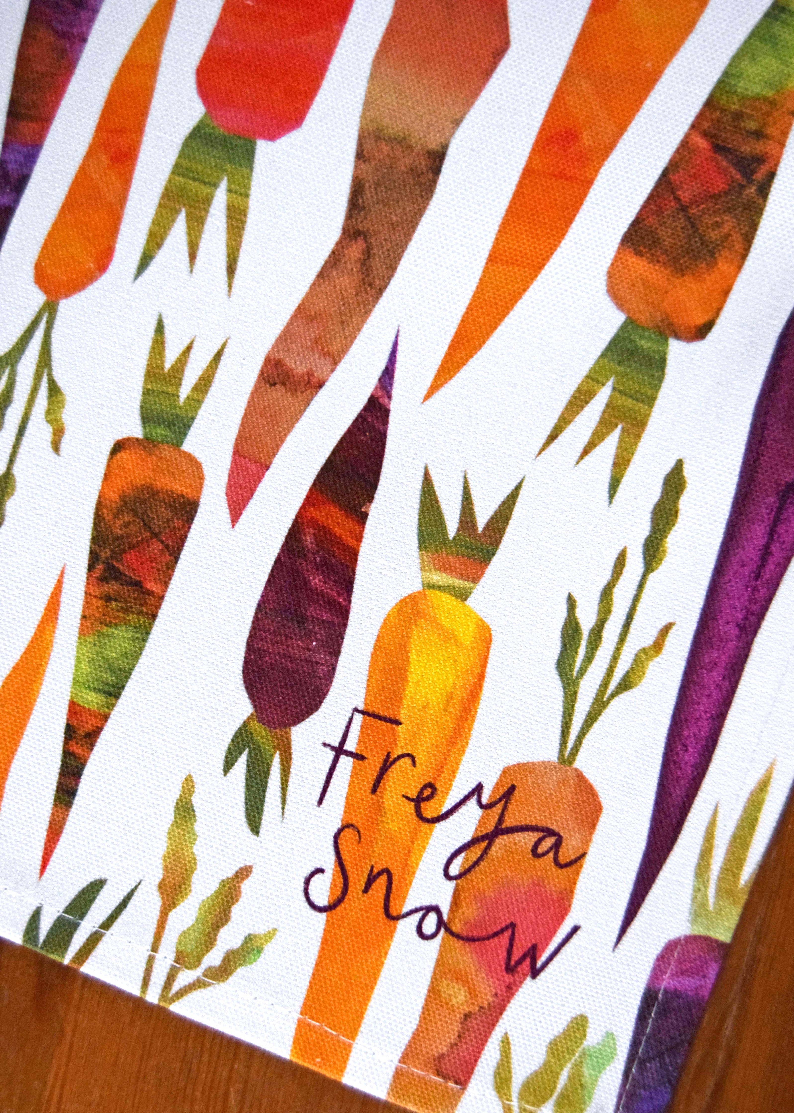 Colorful pattern of carrots with the brand 'Freya Snow' on a white background.