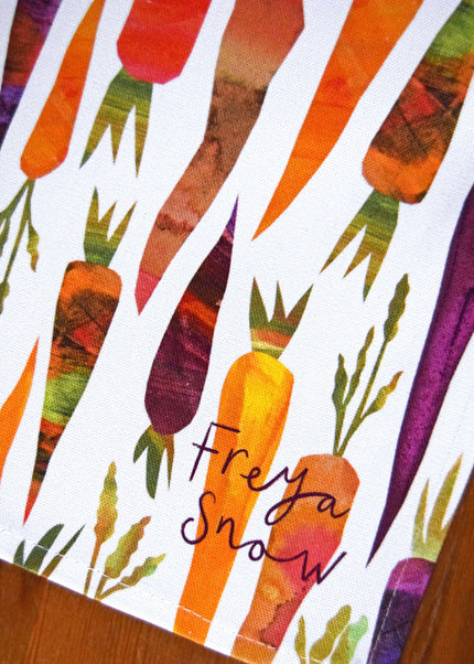 Colorful pattern of carrots with the brand 'Freya Snow' on a white background.