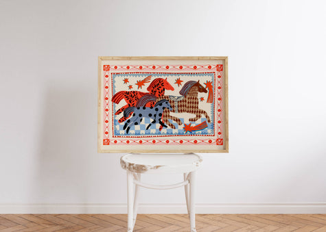 Framed folksy artwork with horses on a white wall