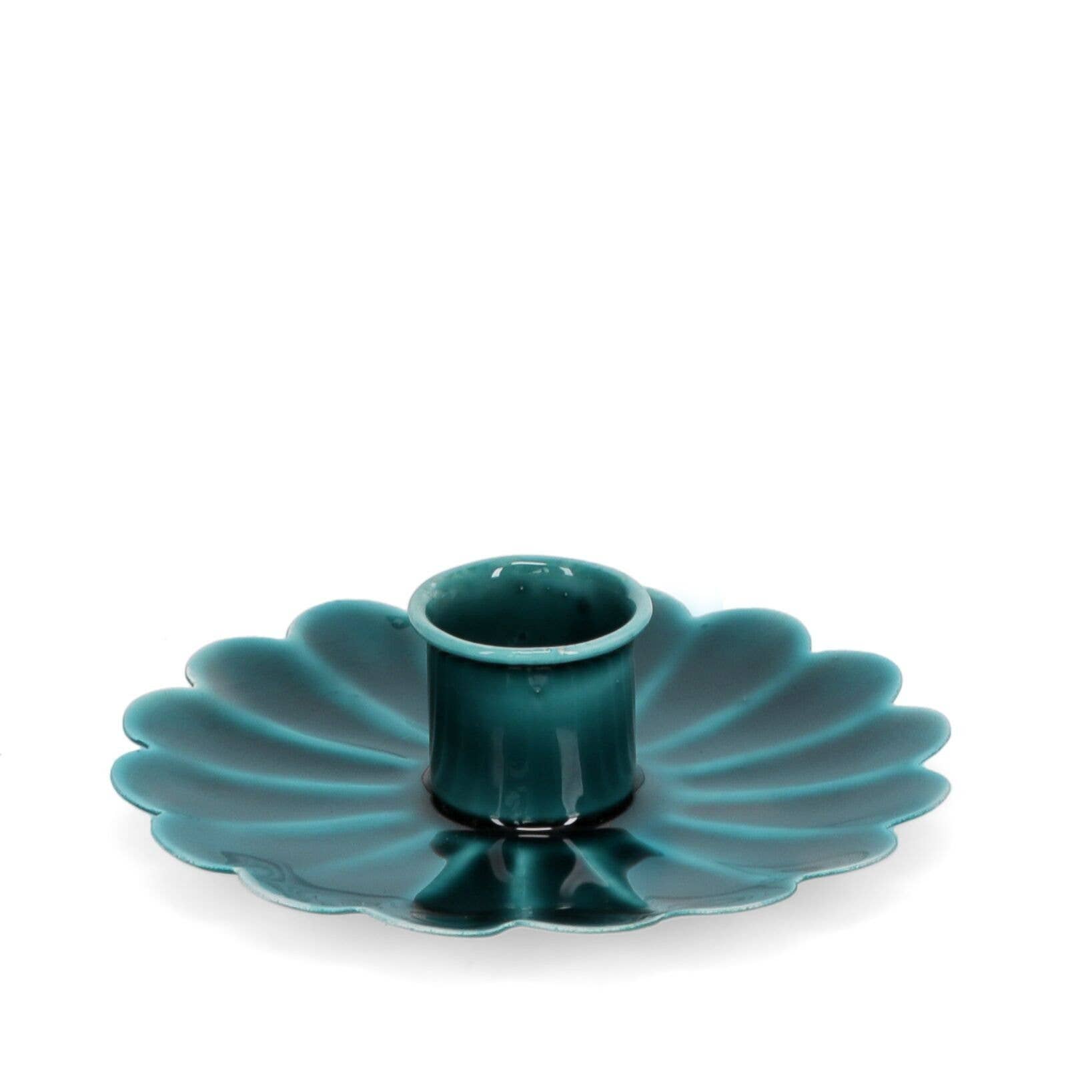 Teal ceramic candle holder with scalloped edge on a white background
