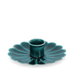 Teal ceramic candle holder with scalloped edge on a white background