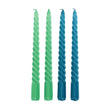 Two pairs of green and blue twisted candles on a white background