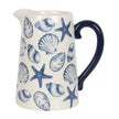 Ceramic pitcher with blue shell and starfish pattern on a white background