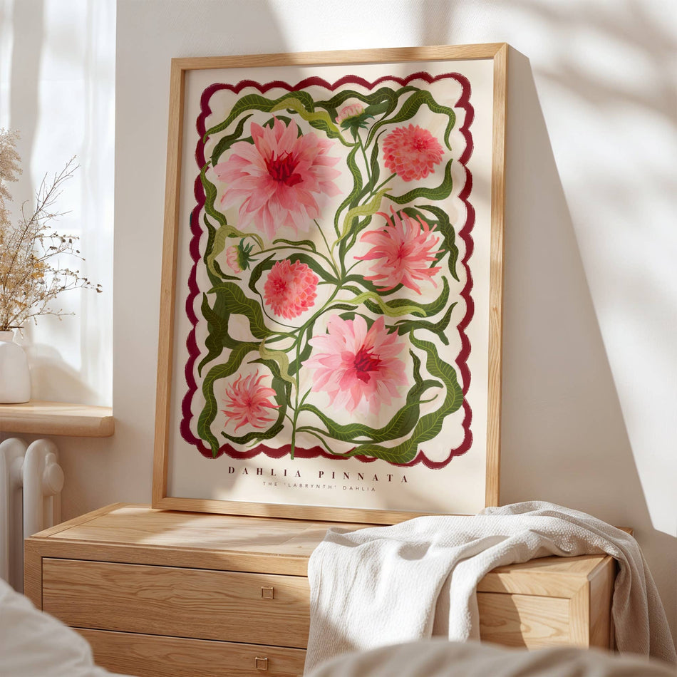 Framed floral artwork on a wall above a wooden dresser.